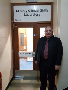 Dr Gray outside the Dr Gray Clinical Skills Laboratory.